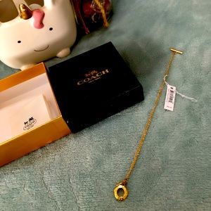 Coach gold-tone bracelet.